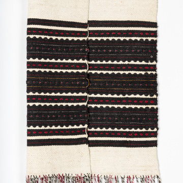 Woven rushnyk (towel) placed under a bread