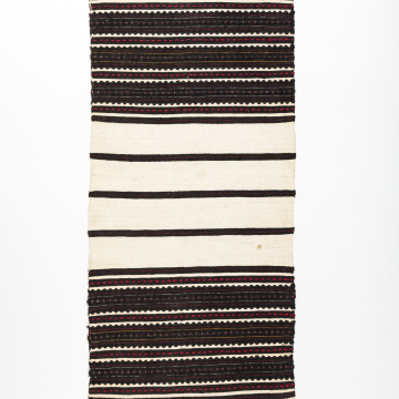Woven rushnyk (towel) placed under a bread