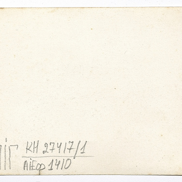 Group of people on a street, with women in traditional attire in the foreground and background