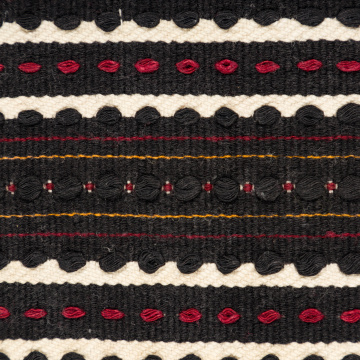Woven rushnyk (towel) placed under a bread