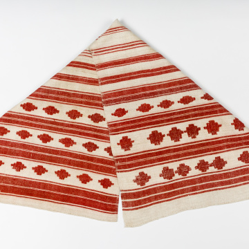 Woven rushnyk (towel) placed under a bread