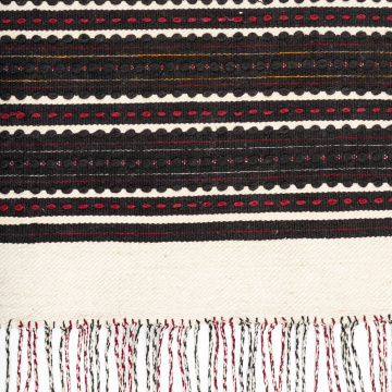 Woven rushnyk (towel) placed under a bread