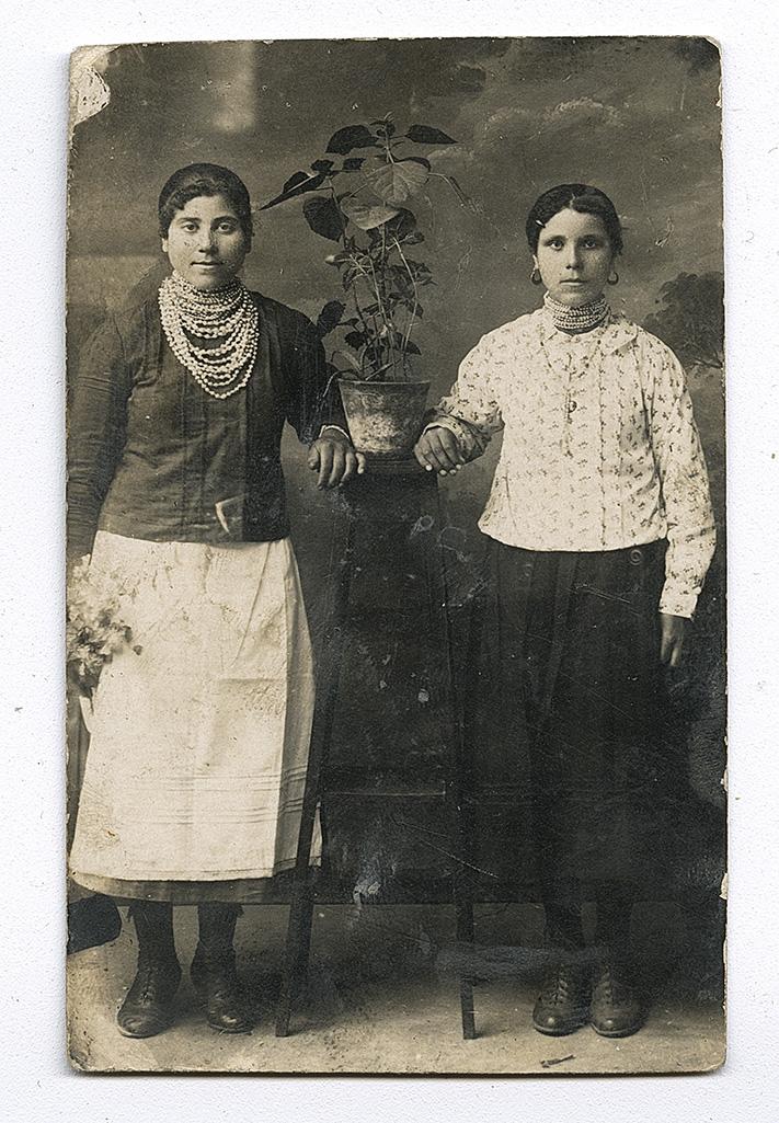 Two women wearing traditional jewelry