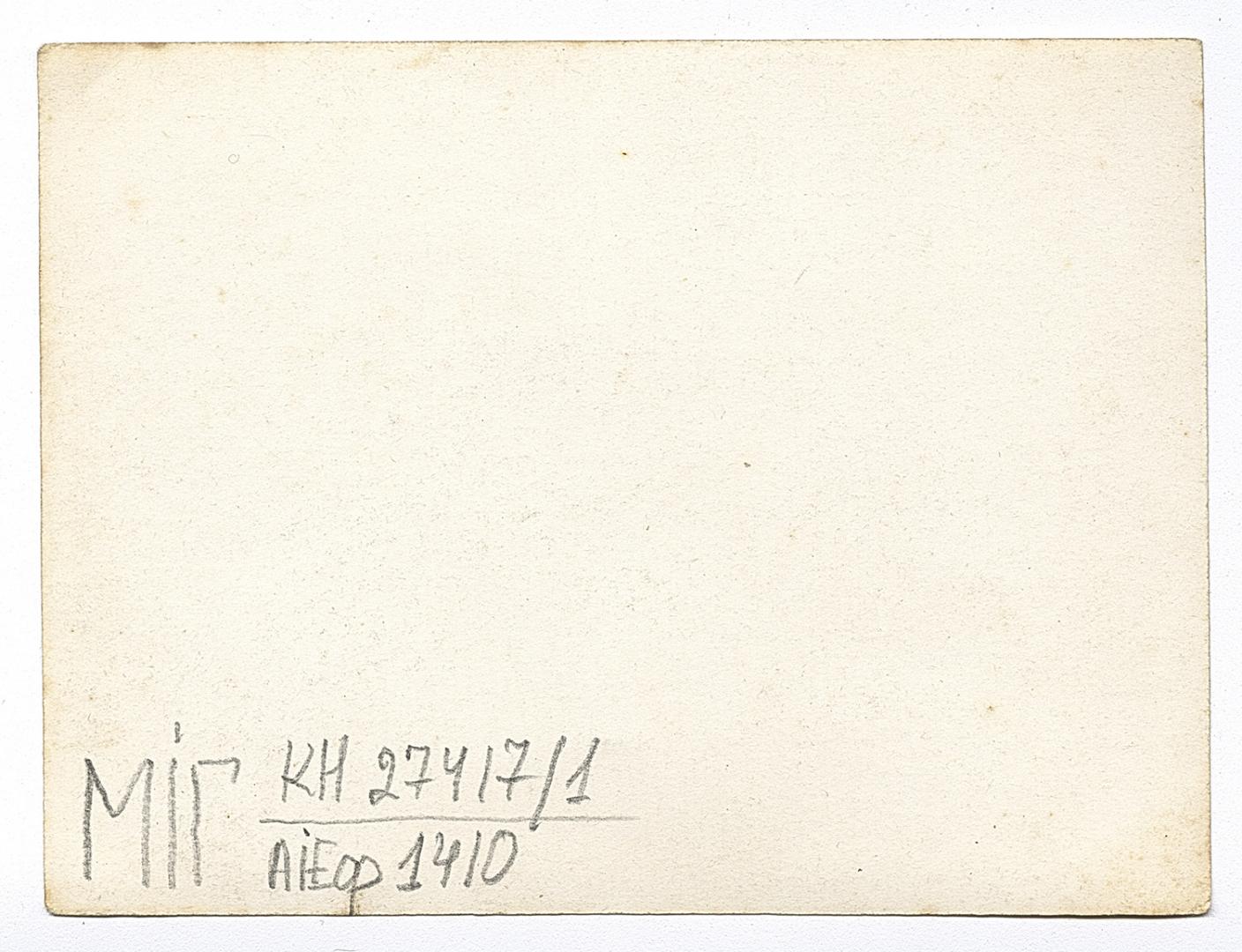 Group of people on a street, with women in traditional attire in the foreground and background