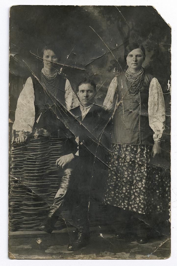 Two women in traditional attire and a man