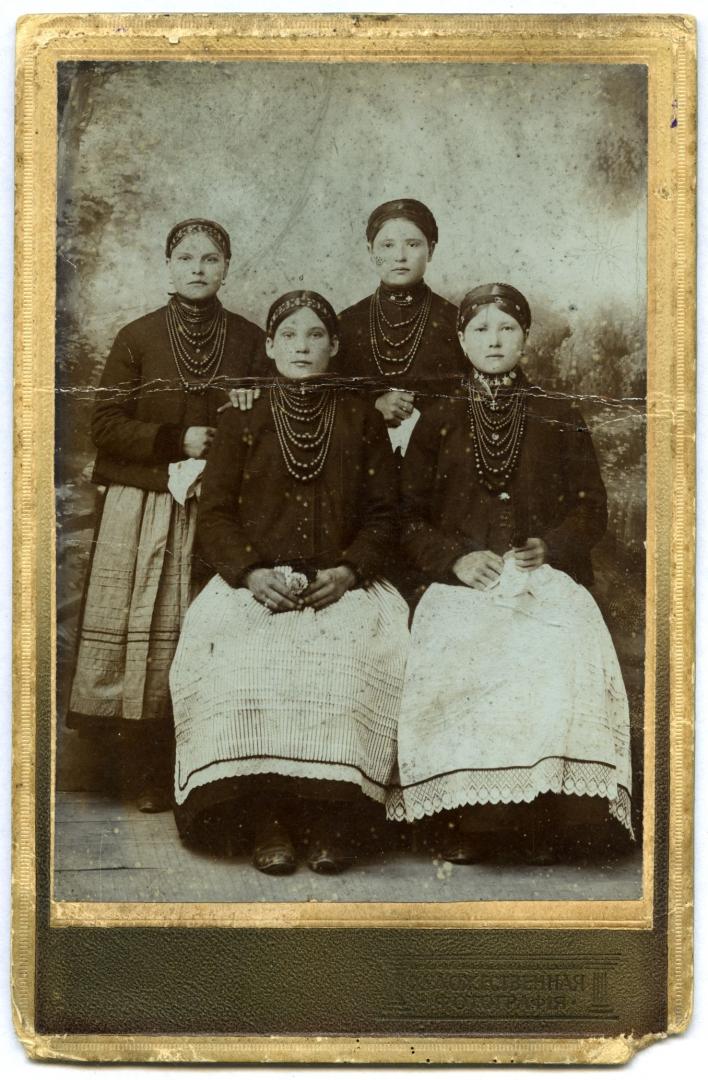 Photo. Four girls wearing necklaces
