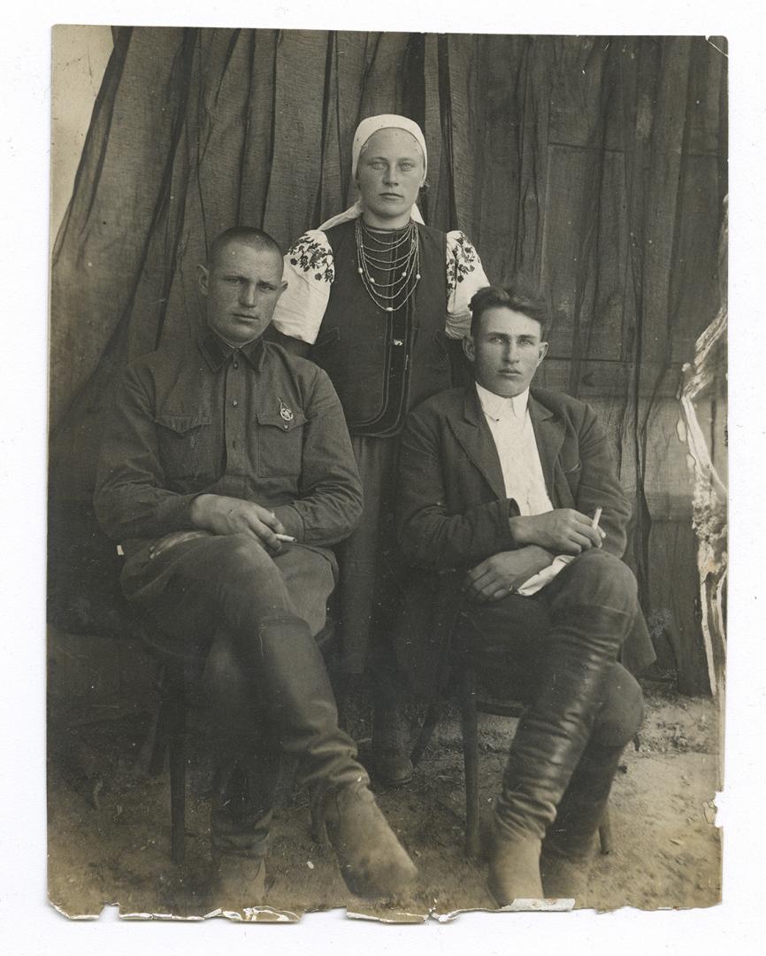 Two men and a woman in traditional attire