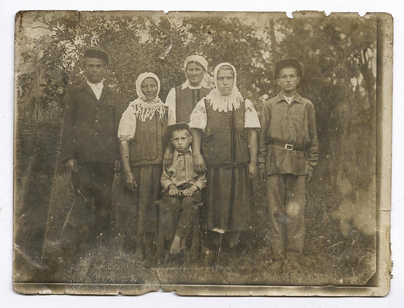 Three women in traditional attire and three boys