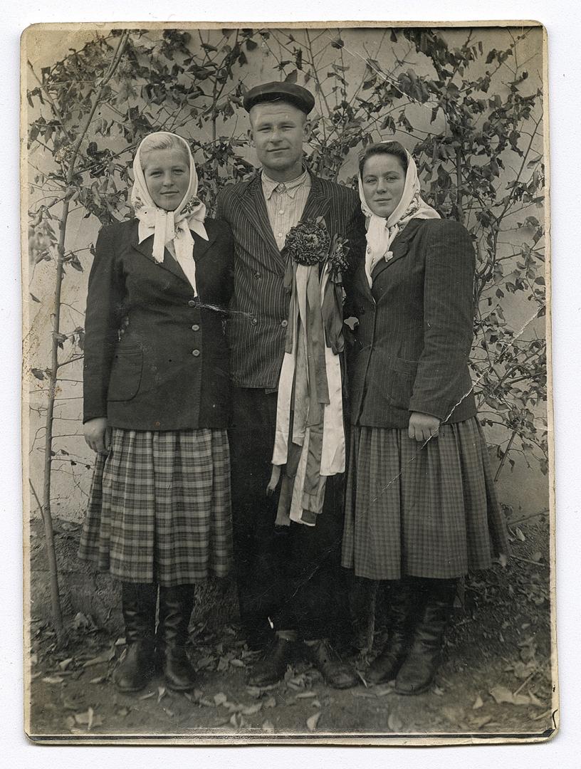 Two women and a man with wedding decor