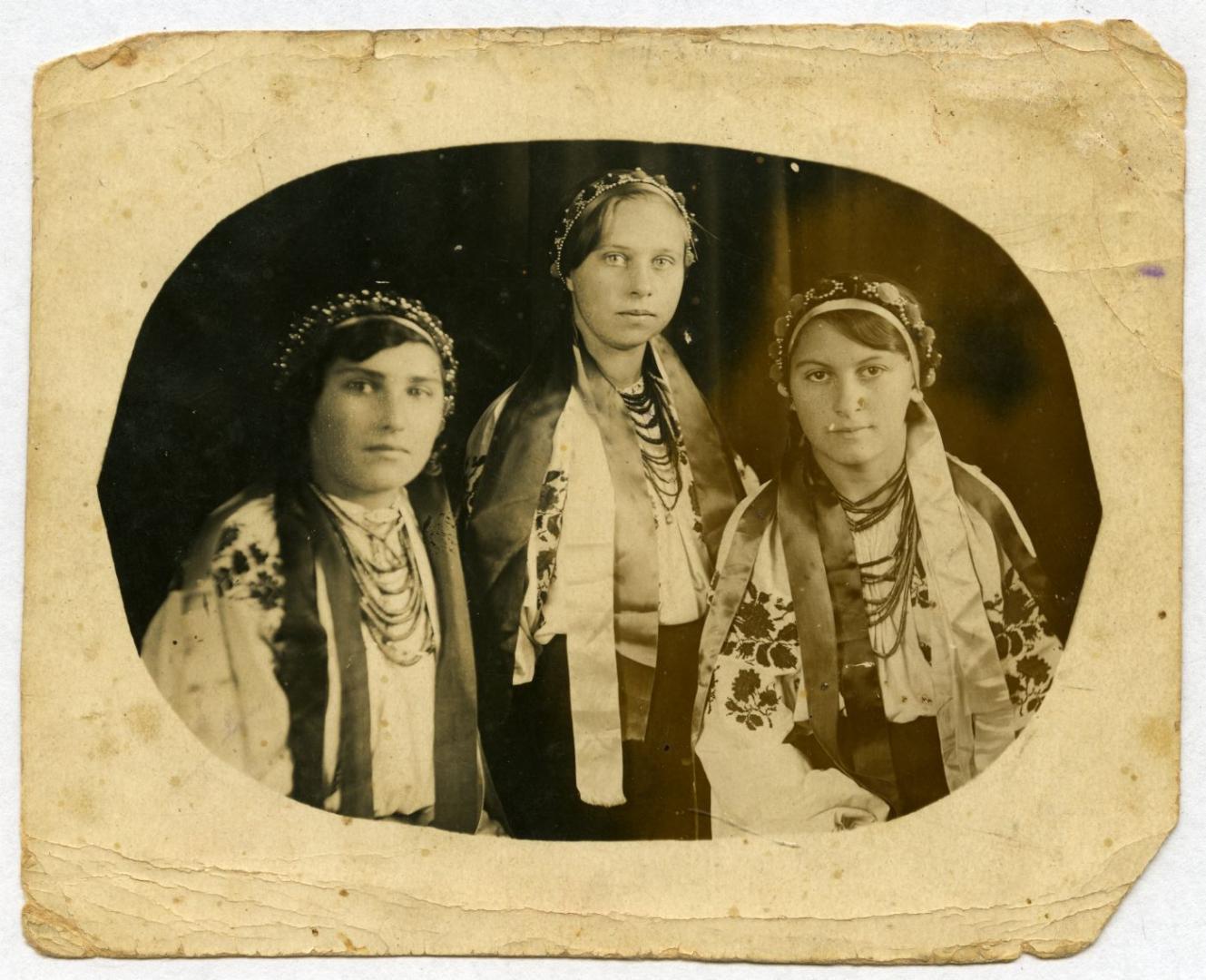 Photo. Three girls wearing festive folk attire