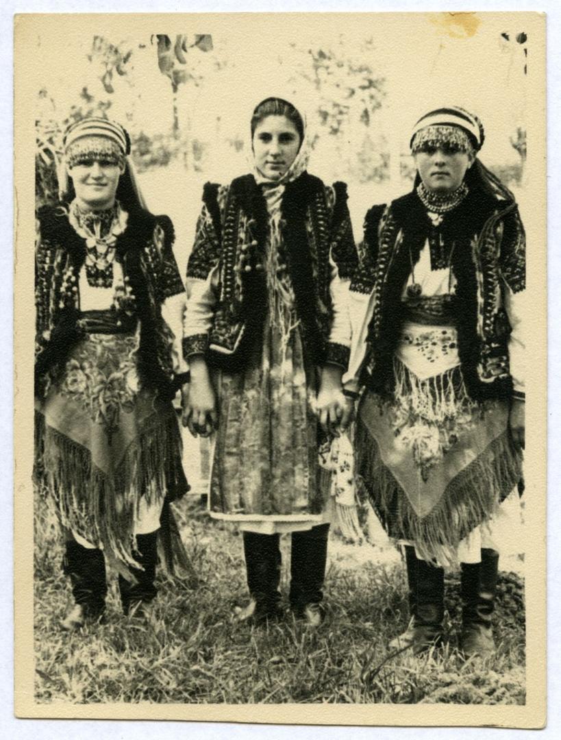 Photo. Girls wearing festive folk attire, chiltsi (decorated headbands), and scarves
