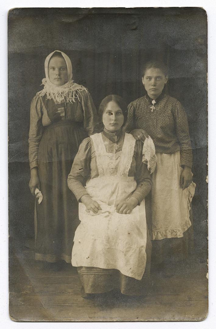 Two girls in traditional jewelry and a woman