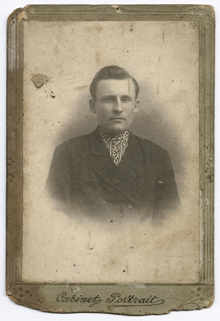 Bust portrait of a young man in an embroidered shirt and jacket