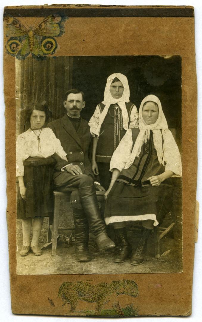 Photo. A husband and a wife with their daughters wearing folk attire