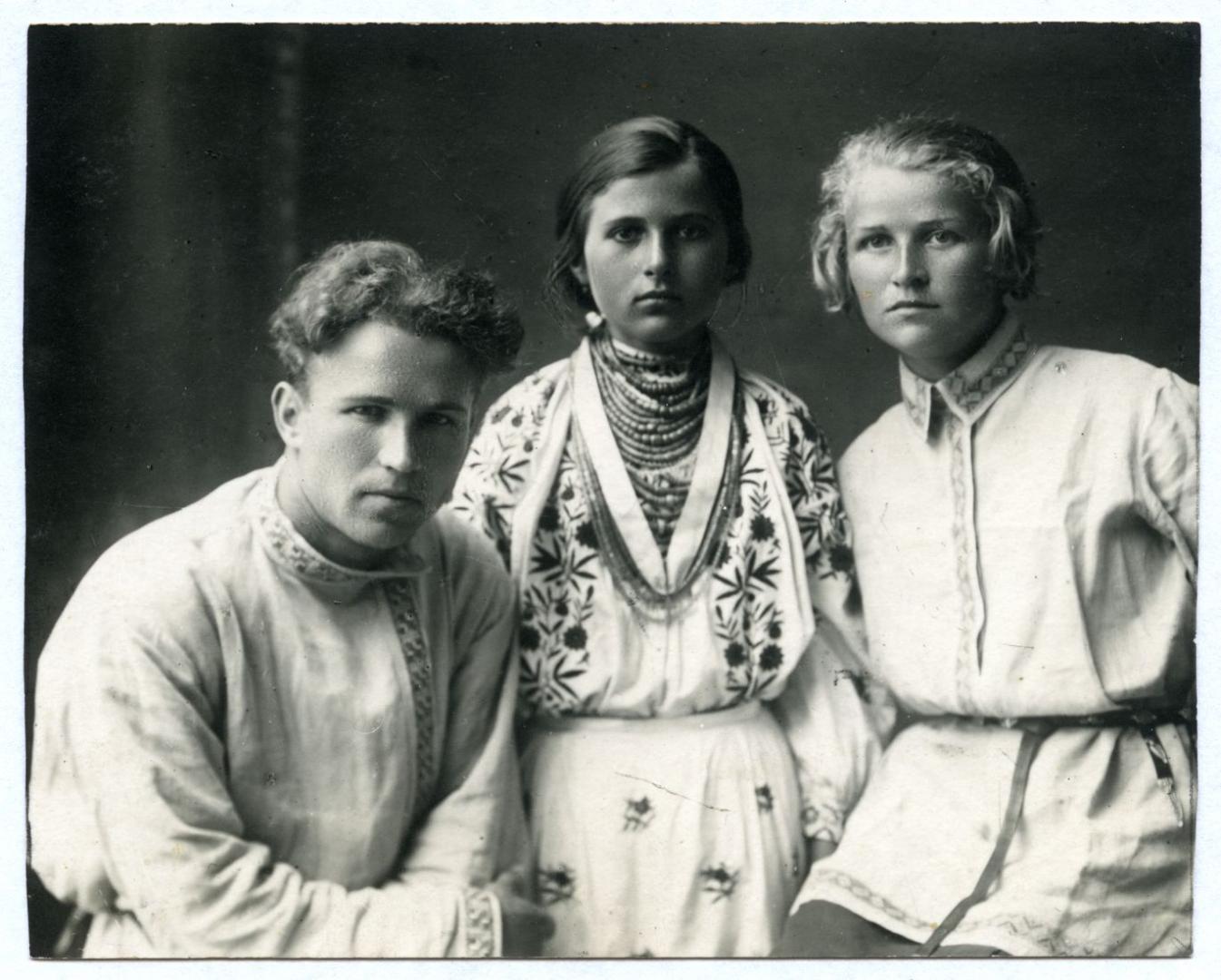 Photo. A young man and two girls wearing folk attire
