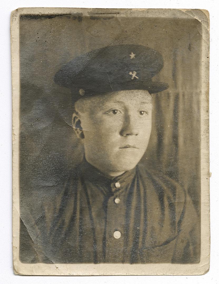 Bust portrait of a young man in a peaked cap