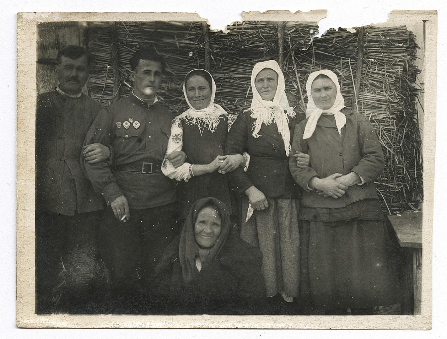 Two men and three women, one in an embroidered shirt