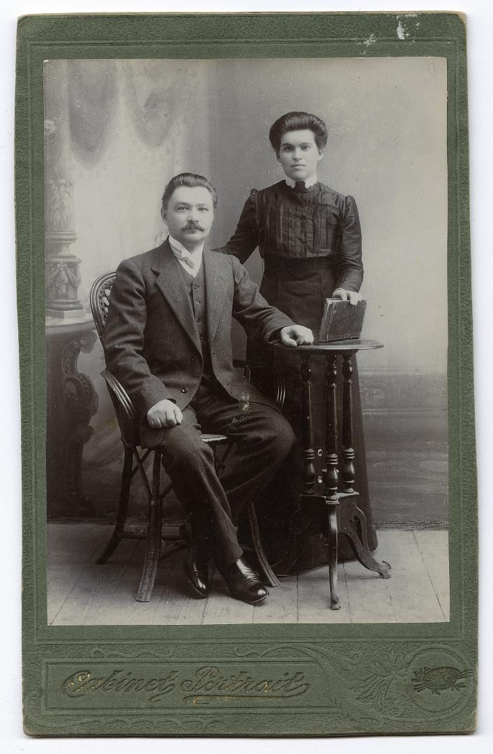 Two women in traditional attire and a man