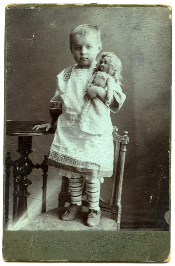 Photo. A girl with a doll