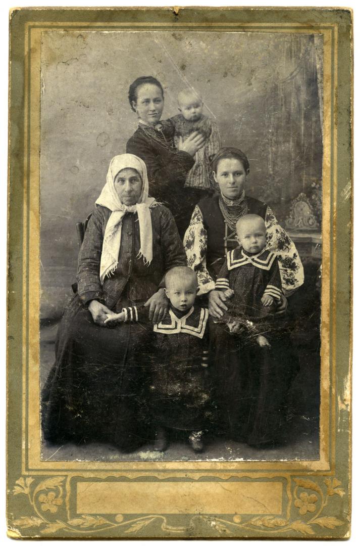 Photo. Women with their children all wearing folk attire