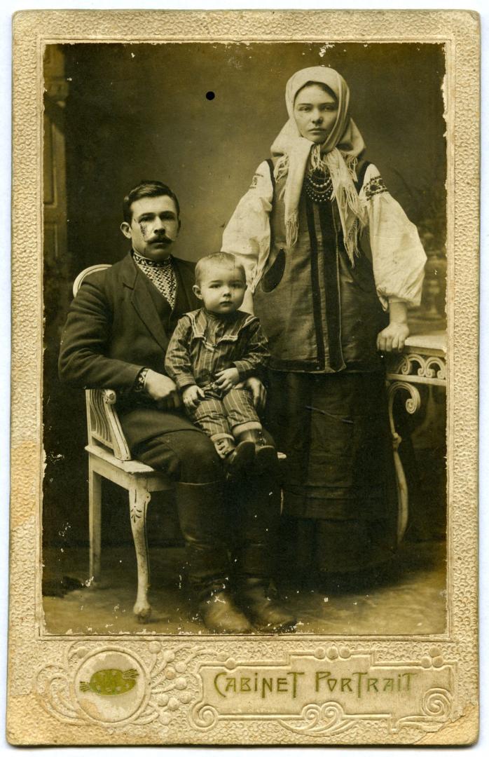 Photo. A man with a boy in his arms and a young woman