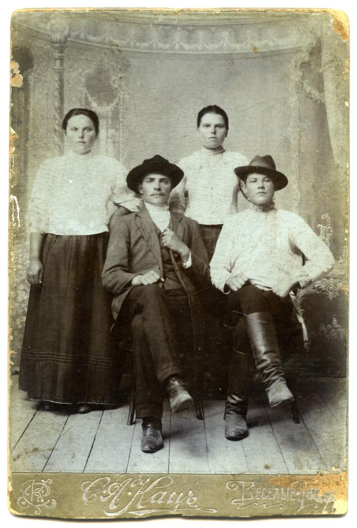 Photo. Young men wearing wide-brimmed hats and two girls