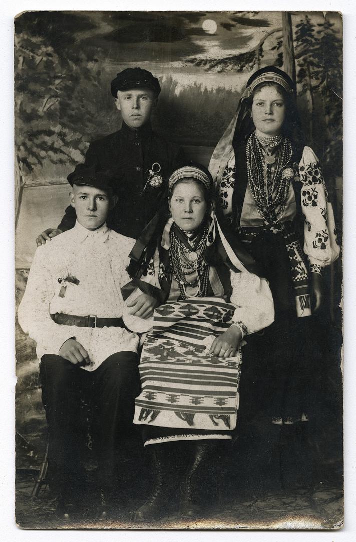 Two girls in traditional attire and two boys