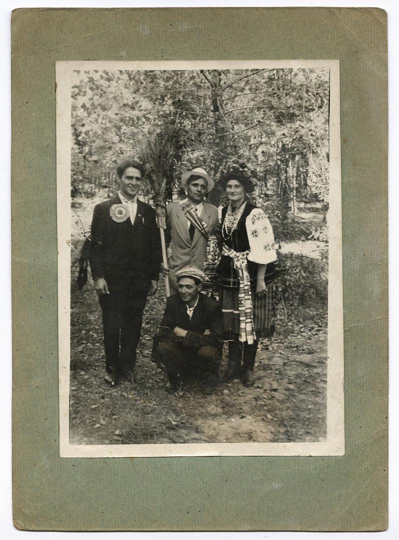 Group wedding photo against a green background