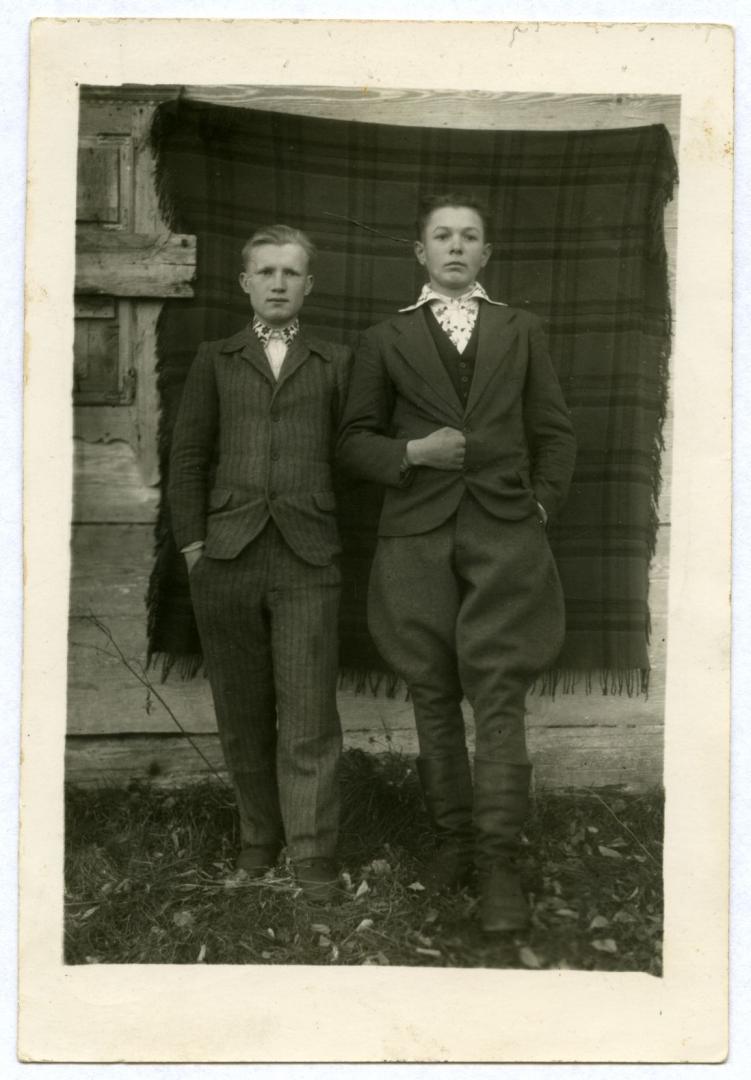 Photo. Two young men near a house