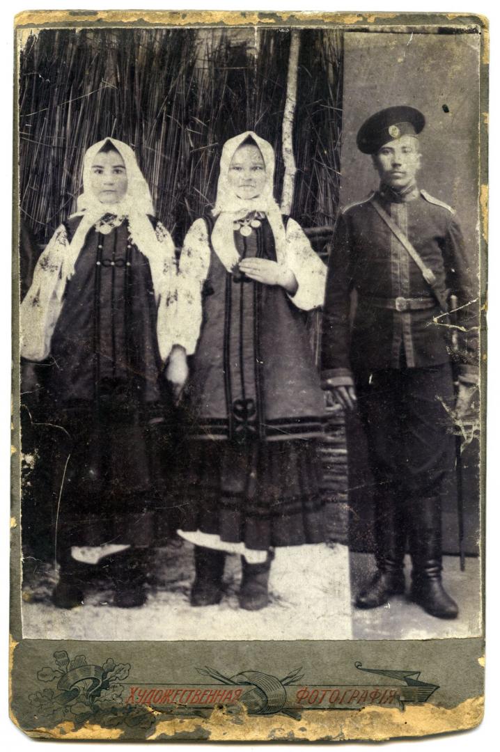 Photomontage. Two young women and a man wearing World War One military uniform