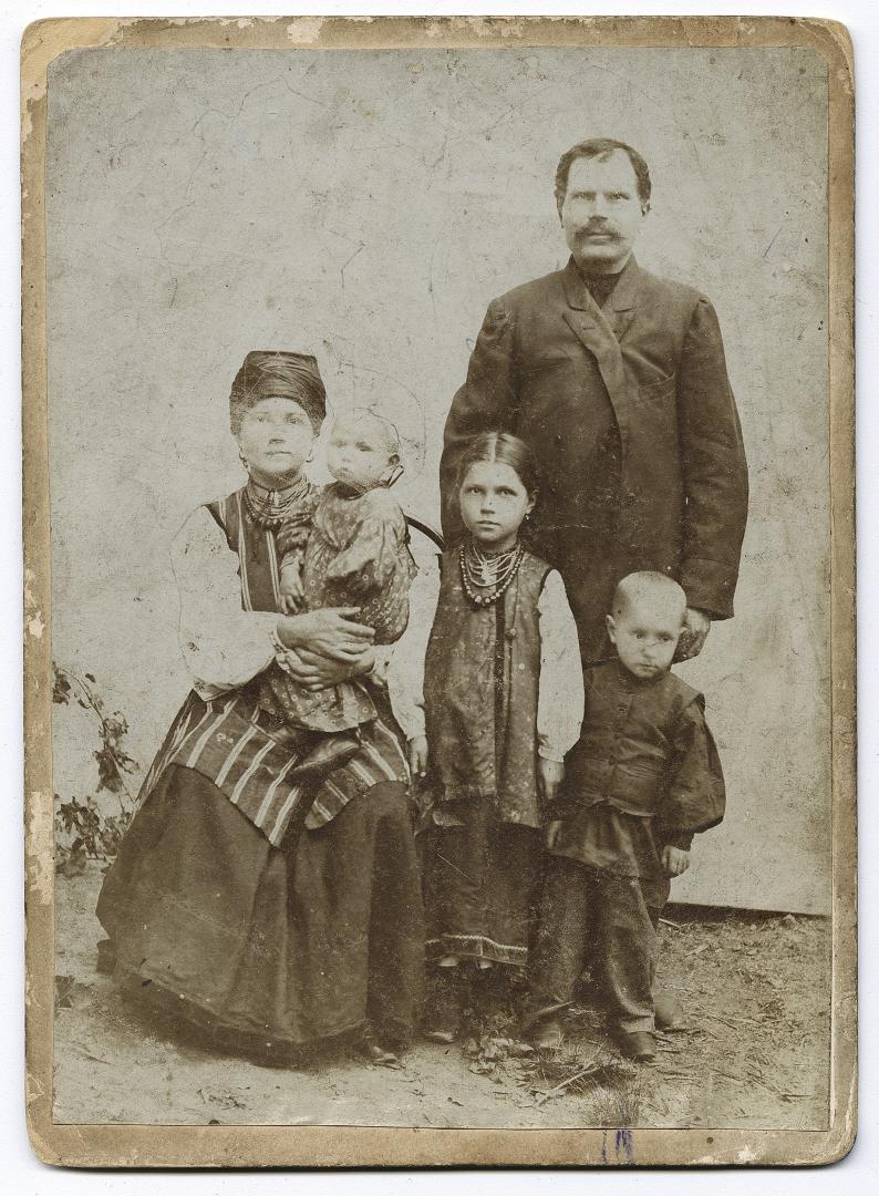 Woman in traditional attire with a man and three children