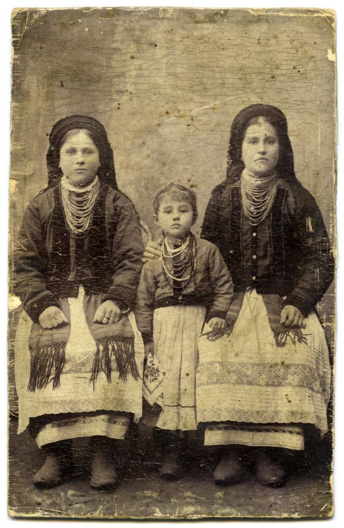 Photo. Two young women and a girl wearing folk attire