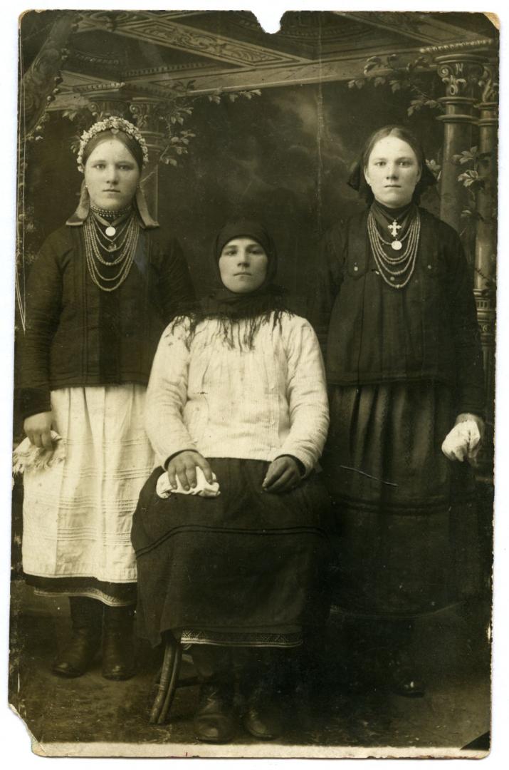 Photo. A mother with two daughters wearing folk attire