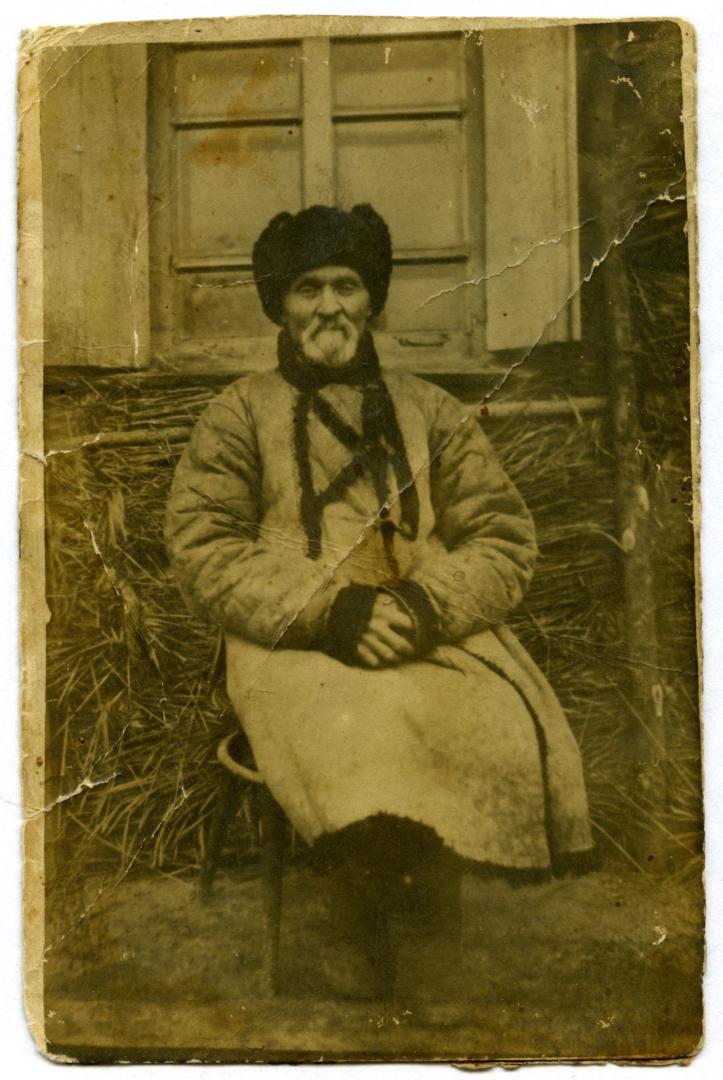 Photo. An old man in a fur coat