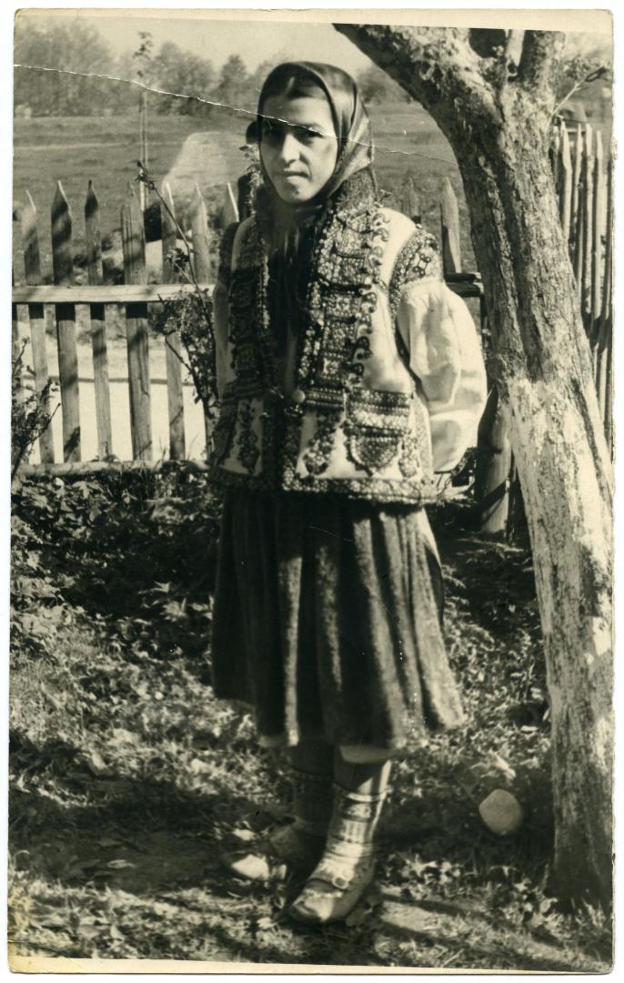 Photo. A young Hutsul girl wearing a Kosmach keptar (sleeveless fur jacket)