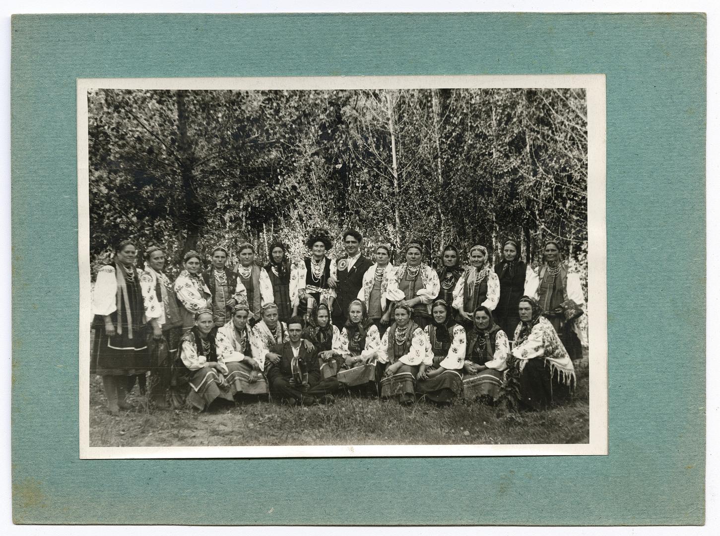 Group wedding photo against a green background