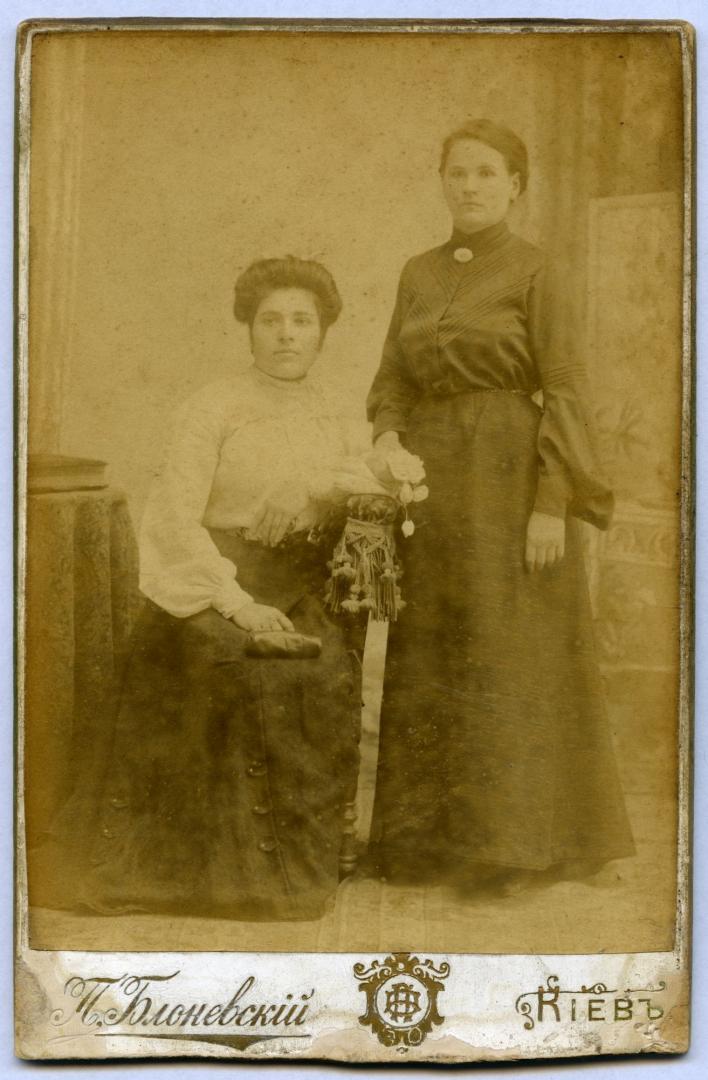 Photo. Two women wearing urban upper-middle class attire