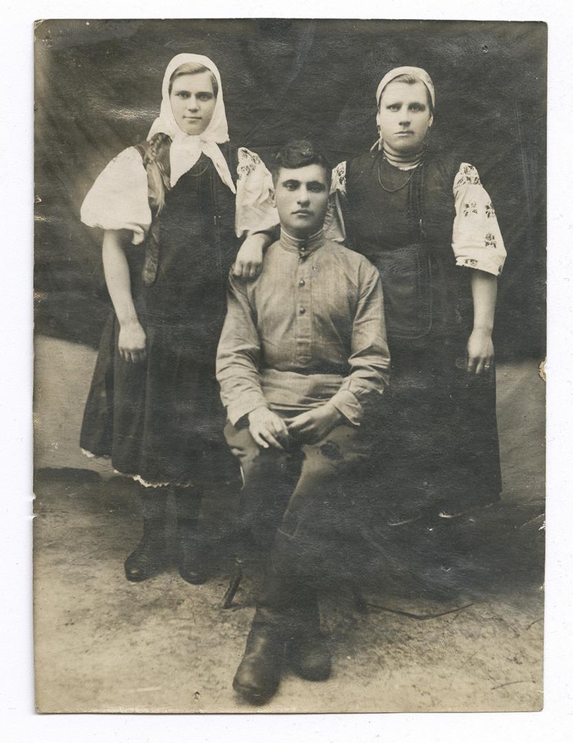 Two women in traditional attire and a man