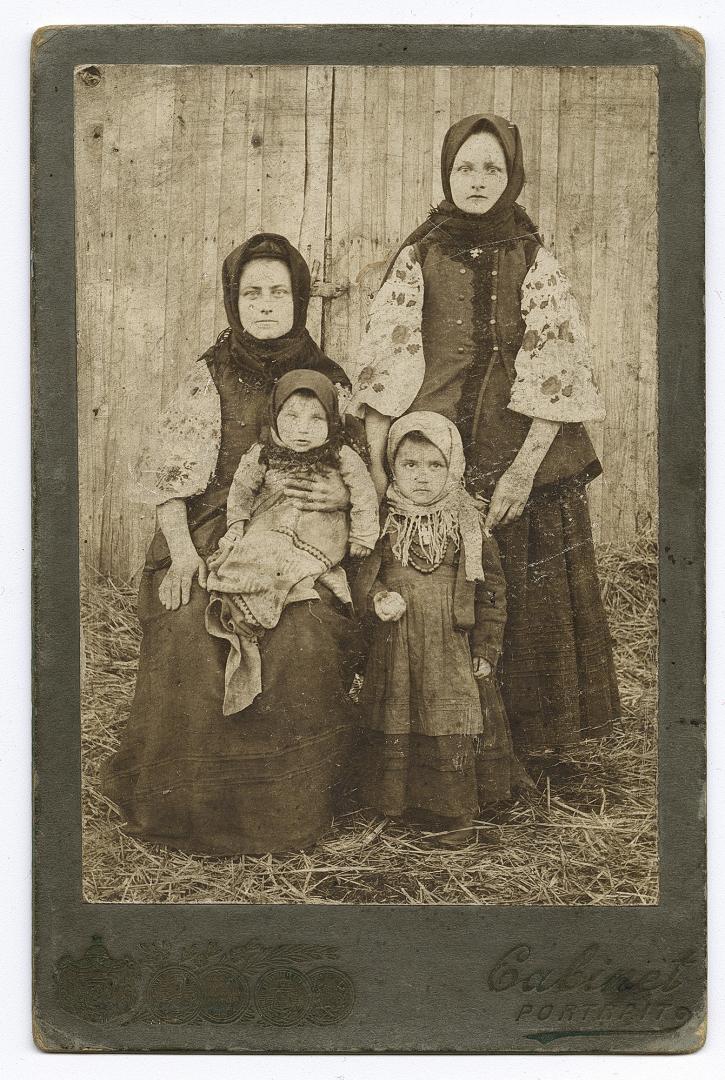 Two women in traditional attire and two girls