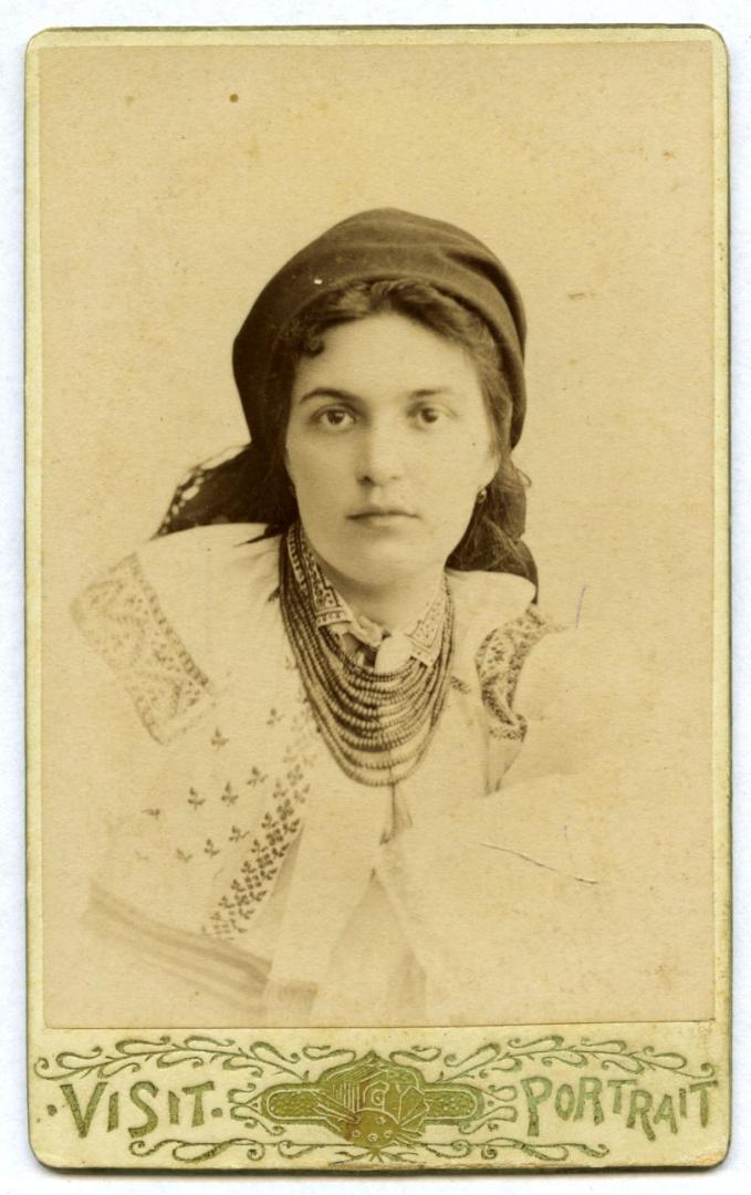 Photo. A headshot of a young woman wearing an embroidered shirt