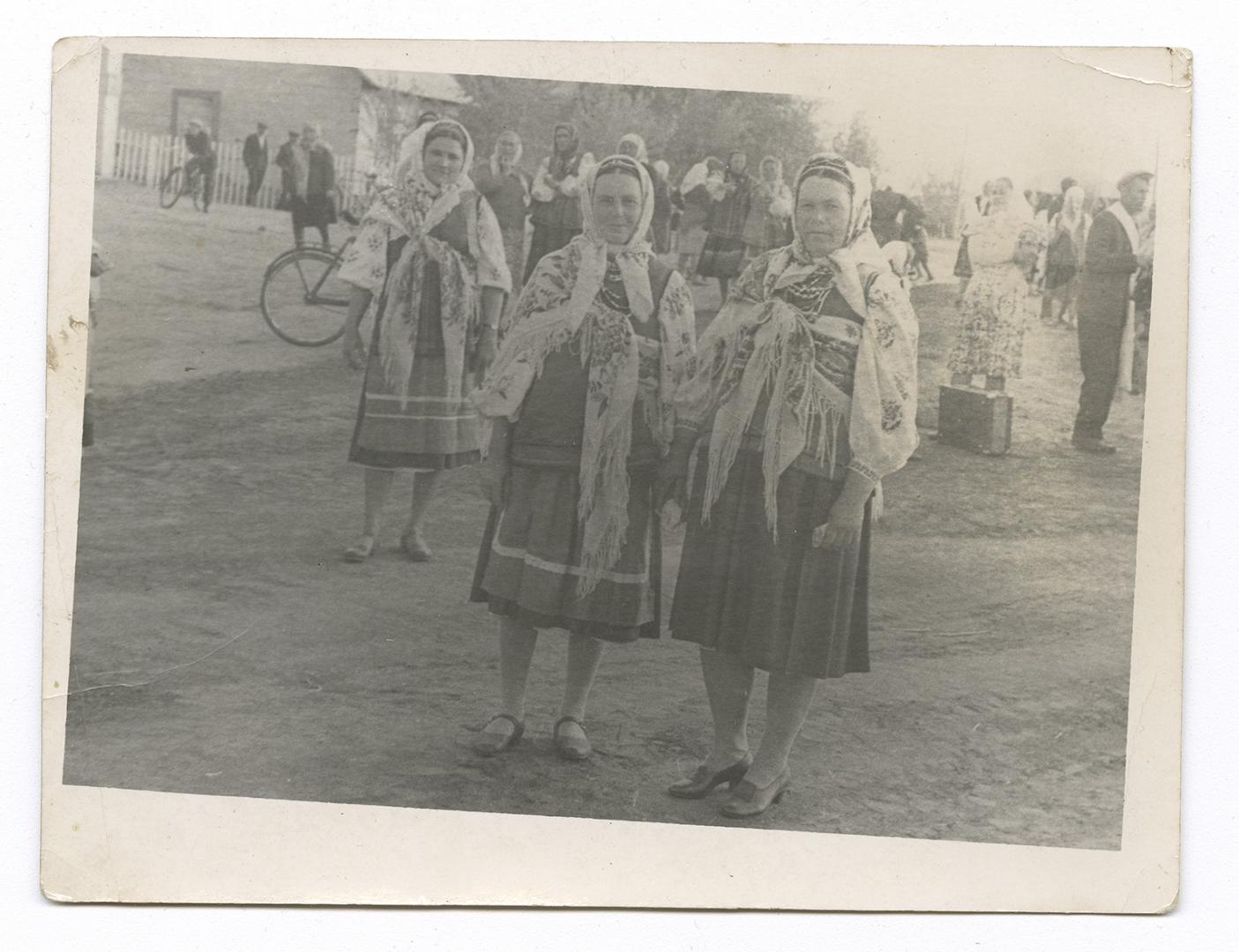 Two women in traditional attire outdoors