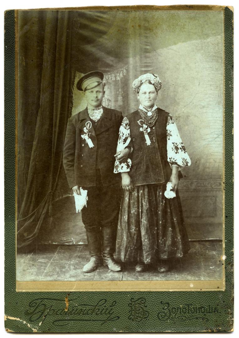 Photo. A bride and a groom wearing folk attire