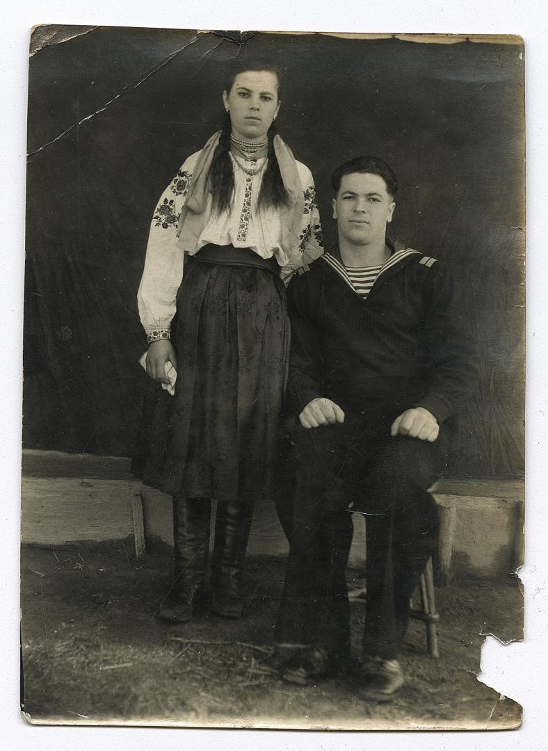 Girl in an embroidered shirt and man in a naval cadet uniform