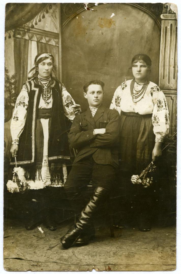 Photo. A young man and girls wearing folk attire
