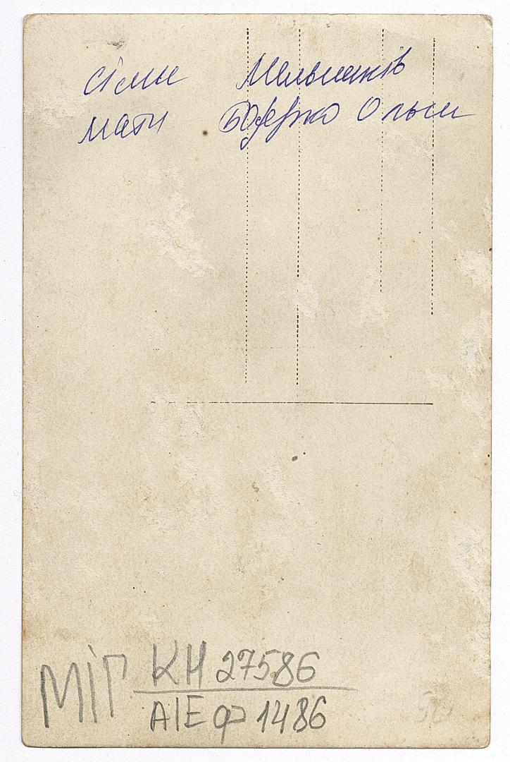 Woman and girl in traditional attire and a boy in an embroidered shirt under outerwear