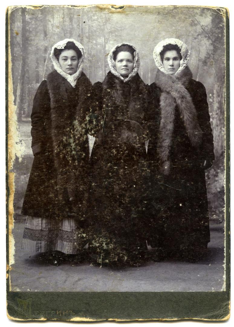 Photo. Three young women wearing winter urban upper-middle class attire