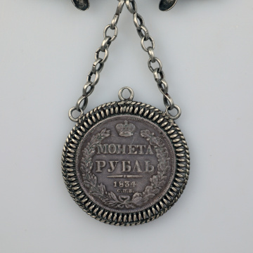 Large dukach (coin-shaped pendants) hung on a ribbon; worn as accessory