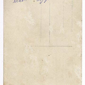 Woman and girl in traditional attire and a boy in an embroidered shirt under outerwear