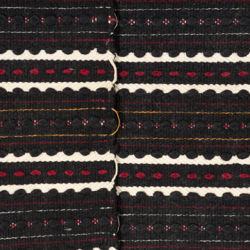 Woven rushnyk (towel) placed under a bread